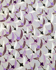 Japanese chiyogami paper featuring purple, black, and white flying cranes on a gray background with metallic gold details.