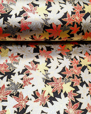 Japanese chiyogami paper featuring red, black, gold, and silver maples leaves on a black background with metallic gold details.