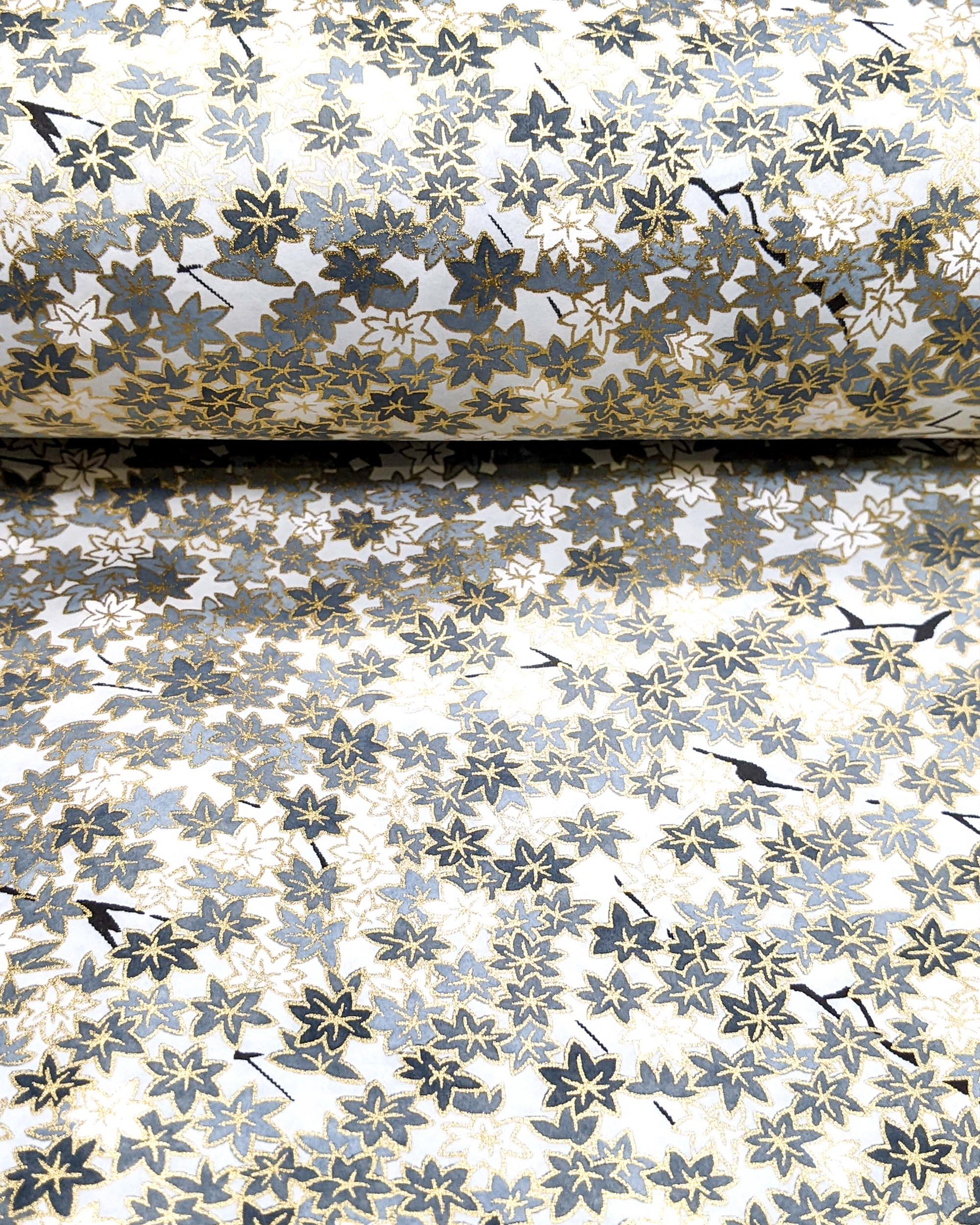 Japanese chiyogami paper featuring small gray and white momiji (maple leaves) on a light gray background with metallic gold details.