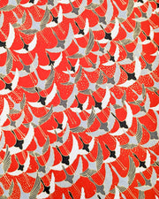 Japanese chiyogami paper featuring gray, black, and white flying cranes on a red background with metallic gold details. 