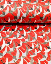 Japanese chiyogami paper featuring gray, black, and white flying cranes on a red background with metallic gold details. 
