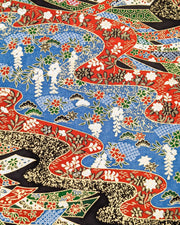 Japanese chiyogami paper featuring red, white, blue, and green ribbons decorated with traditional Japanese motifs on a black, blue, and red background with metallic gold details. The design includes scattered red and green cherry blossoms, green and black pines, red and black maples leaves, and white wisterias.