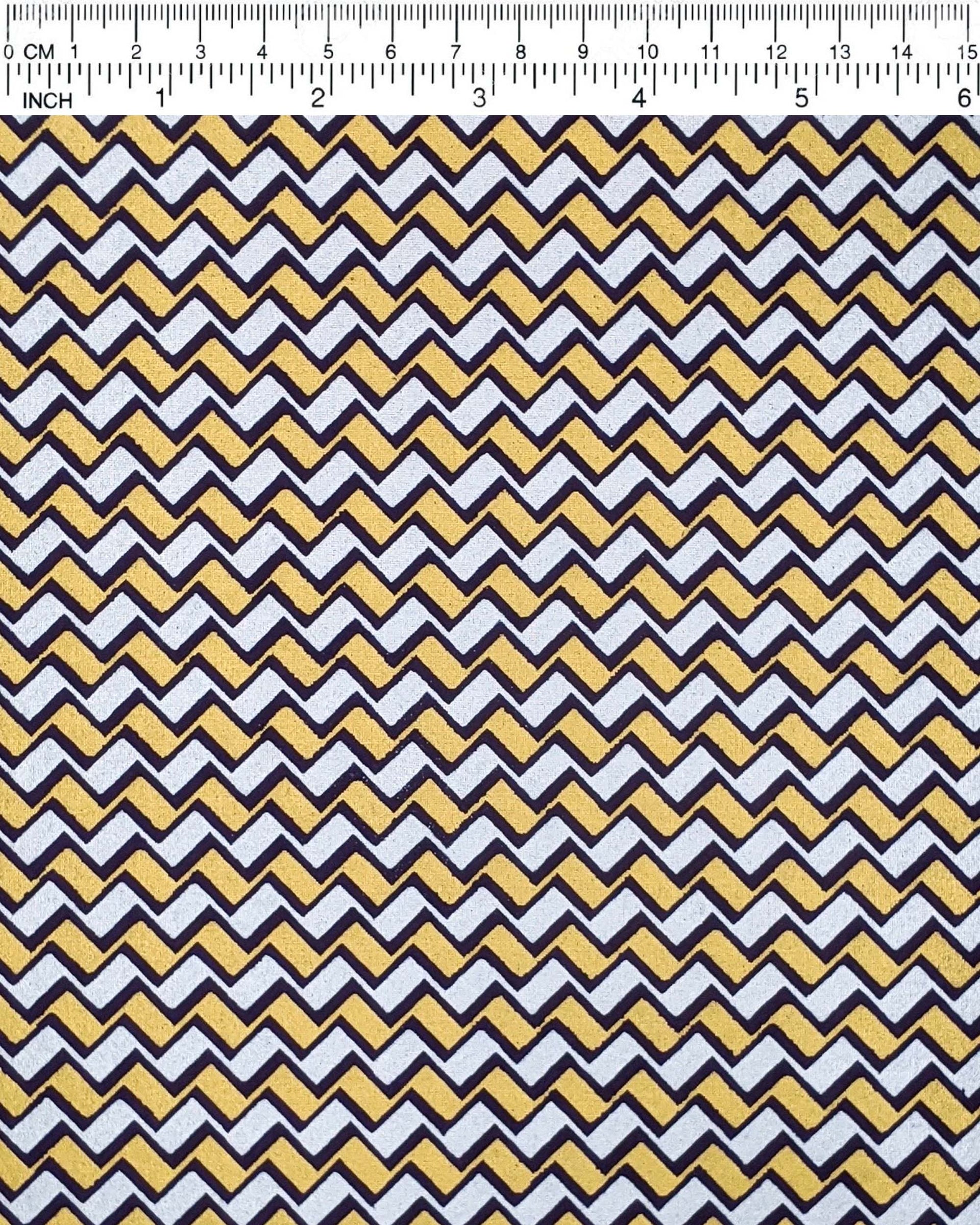 Japanese chiyogami paper featuring a navy blue, metallic silver, and metallic gold zigzag chevron pattern.