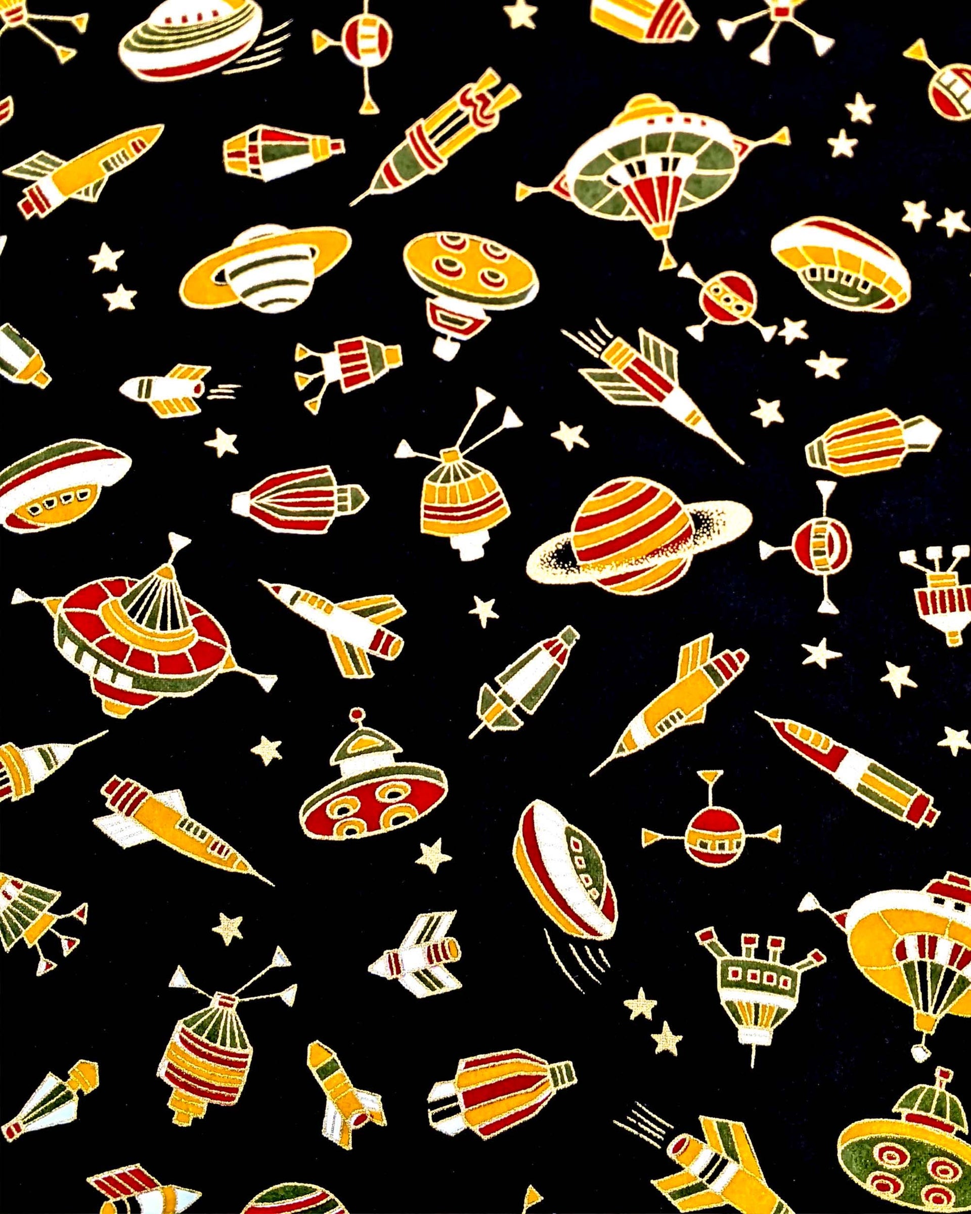 satellites, and planets surrounded by small gold stars on a black background with metallic gold accents.