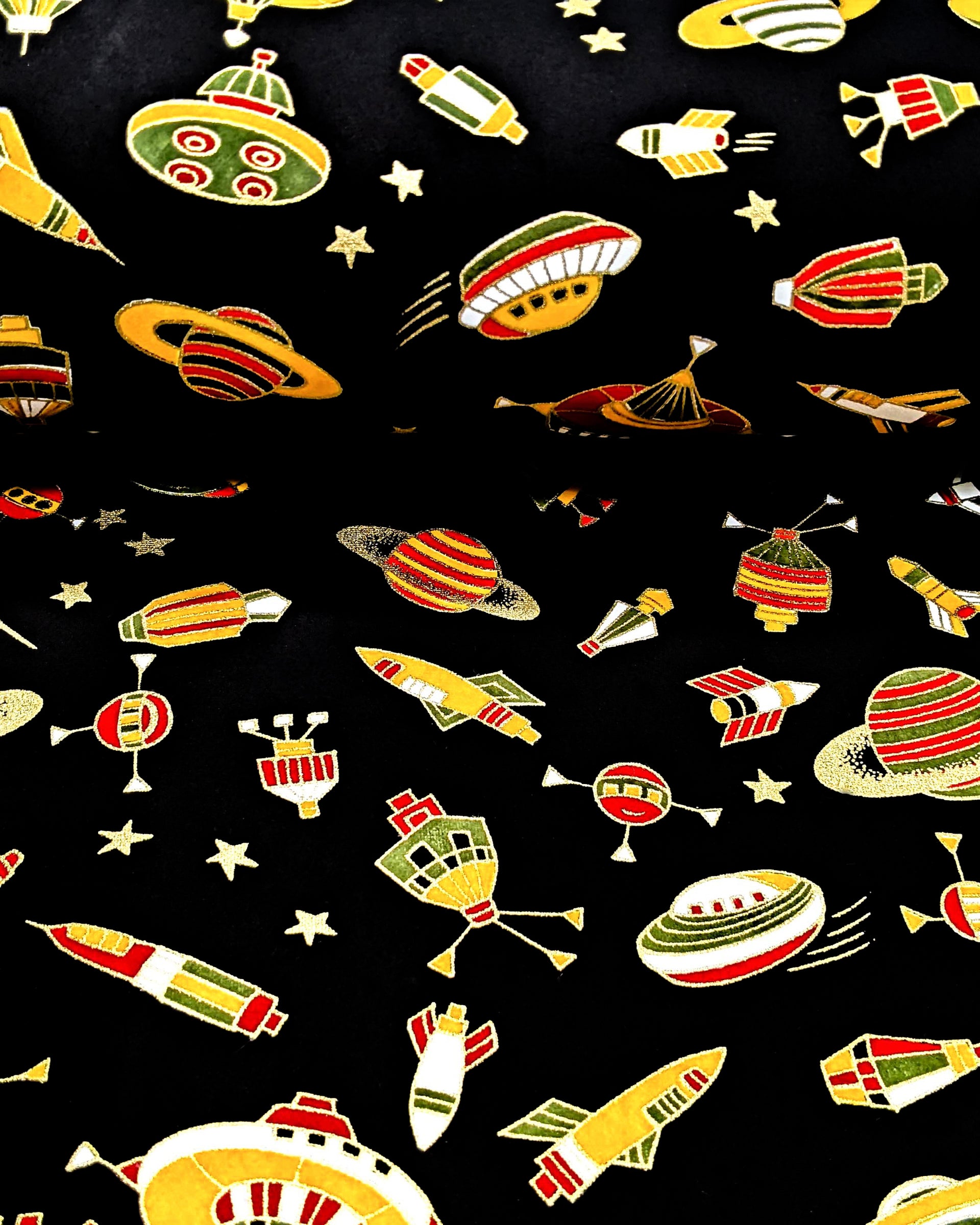 satellites, and planets surrounded by small gold stars on a black background with metallic gold accents.