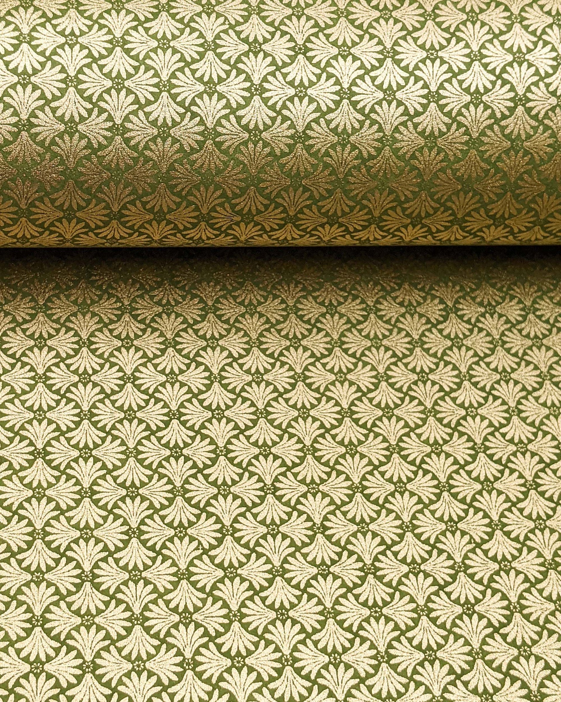Japanese chiyogami paper featuring metallic gold geometric stylized flowers on a green background.
