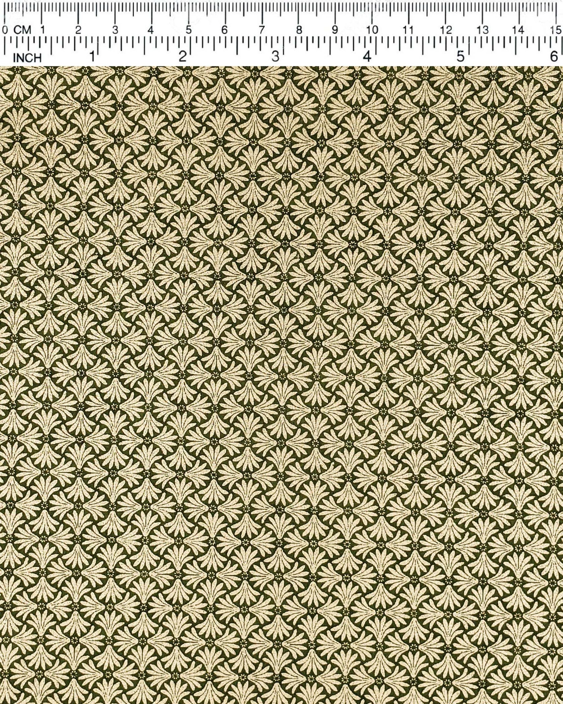 Japanese chiyogami paper featuring metallic gold geometric stylized flowers on a green background.