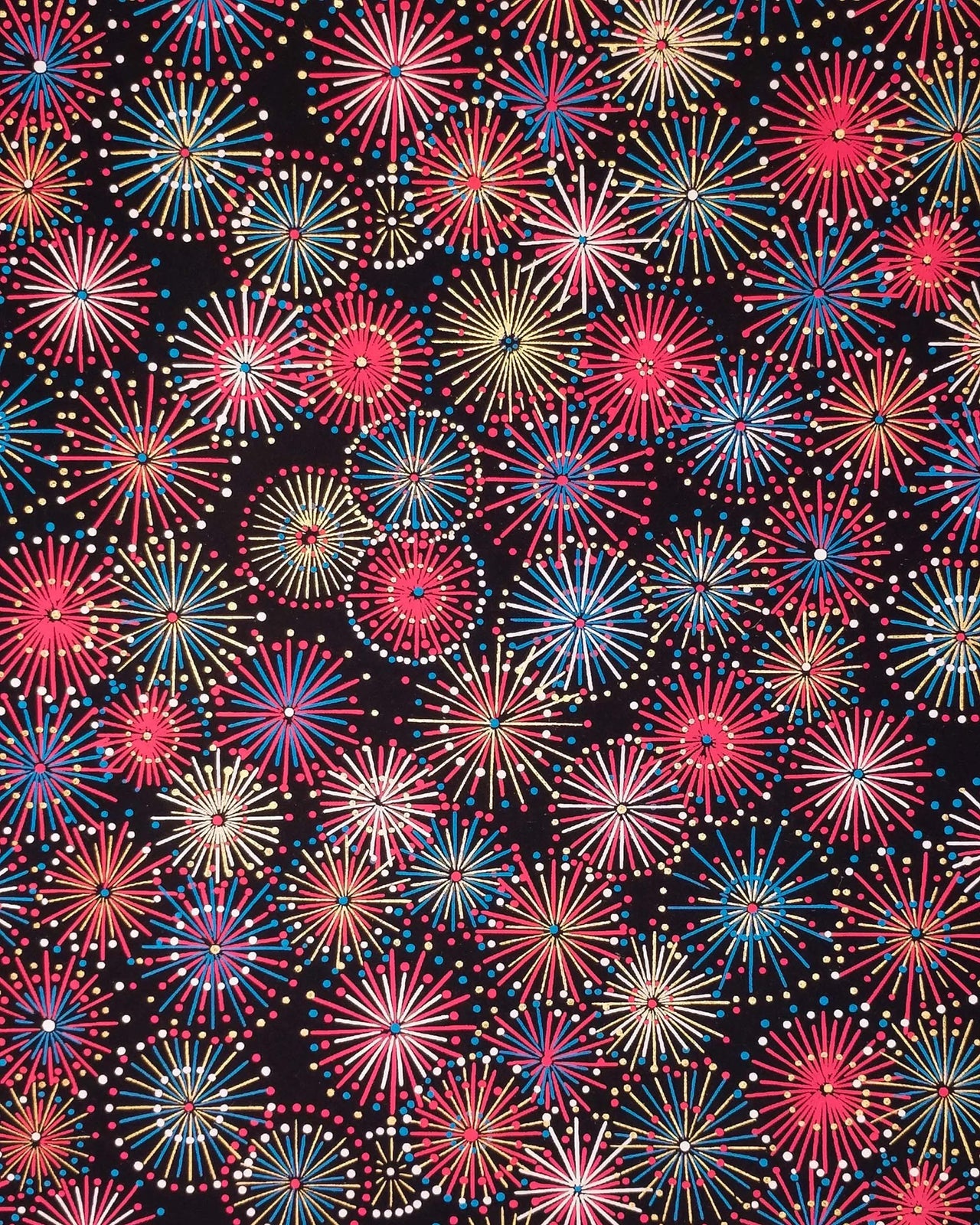 Japanese chiyogami paper featuring colorful red, blue, pink, and white exploding fireworks on a black background with metallic gold accents.
