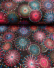 Japanese chiyogami paper featuring colorful red, blue, pink, and white exploding fireworks on a black background with metallic gold accents.