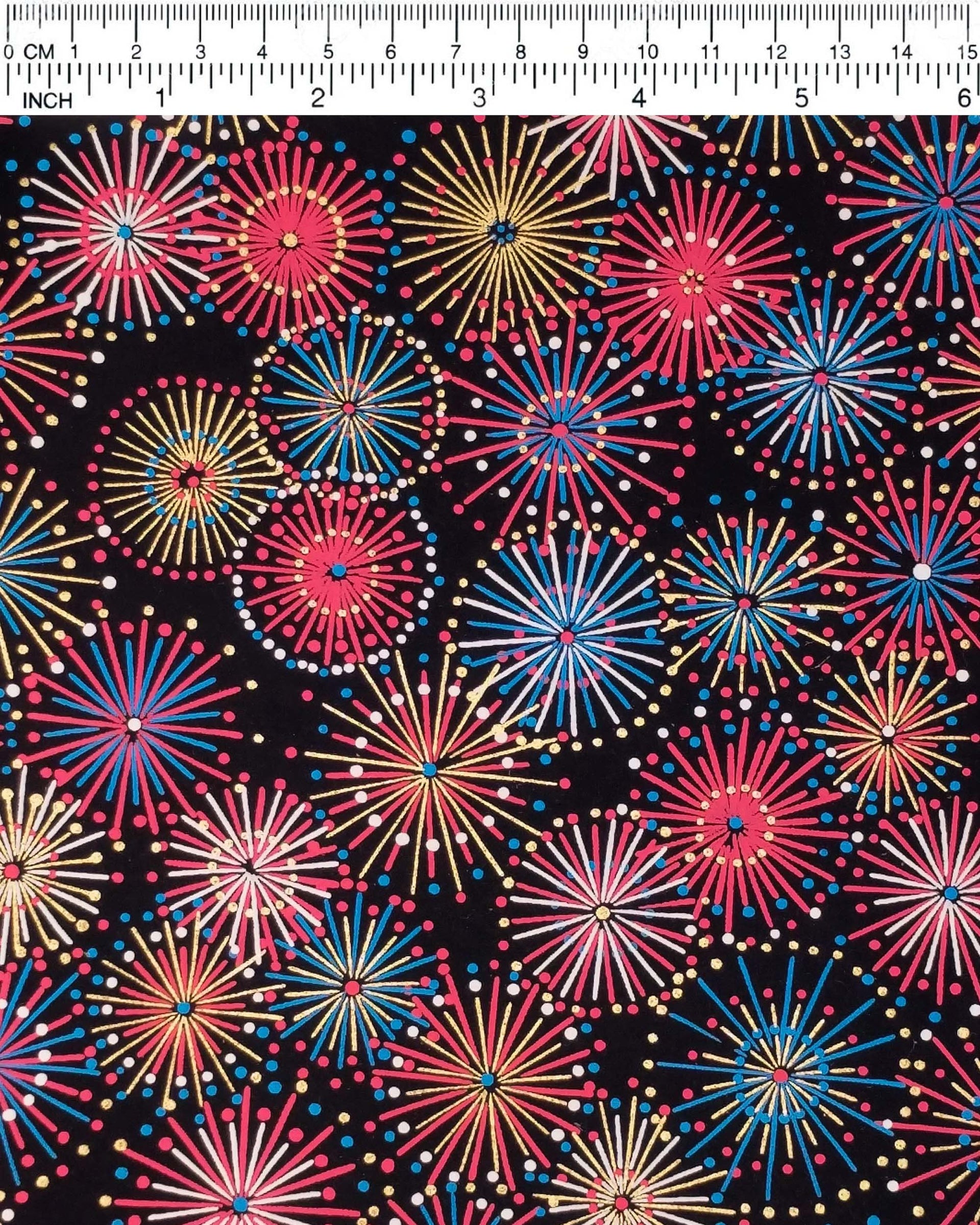 Japanese chiyogami paper featuring colorful red, blue, pink, and white exploding fireworks on a black background with metallic gold accents.