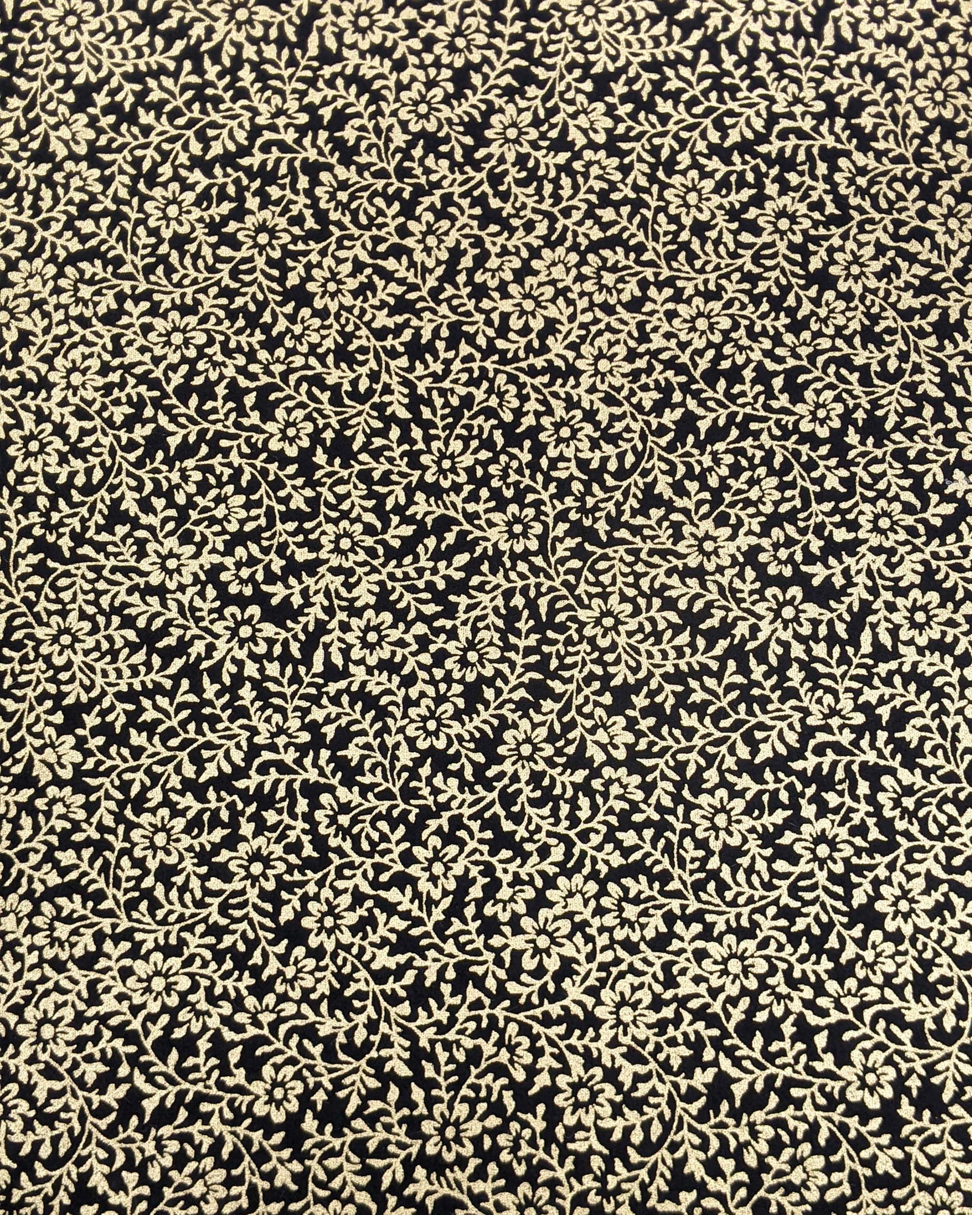 Japanese chiyogami paper featuring a metallic gold floral motif on a black background.