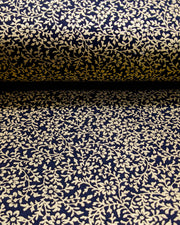 Japanese chiyogami paper featuring a metallic gold floral motif on a black background.