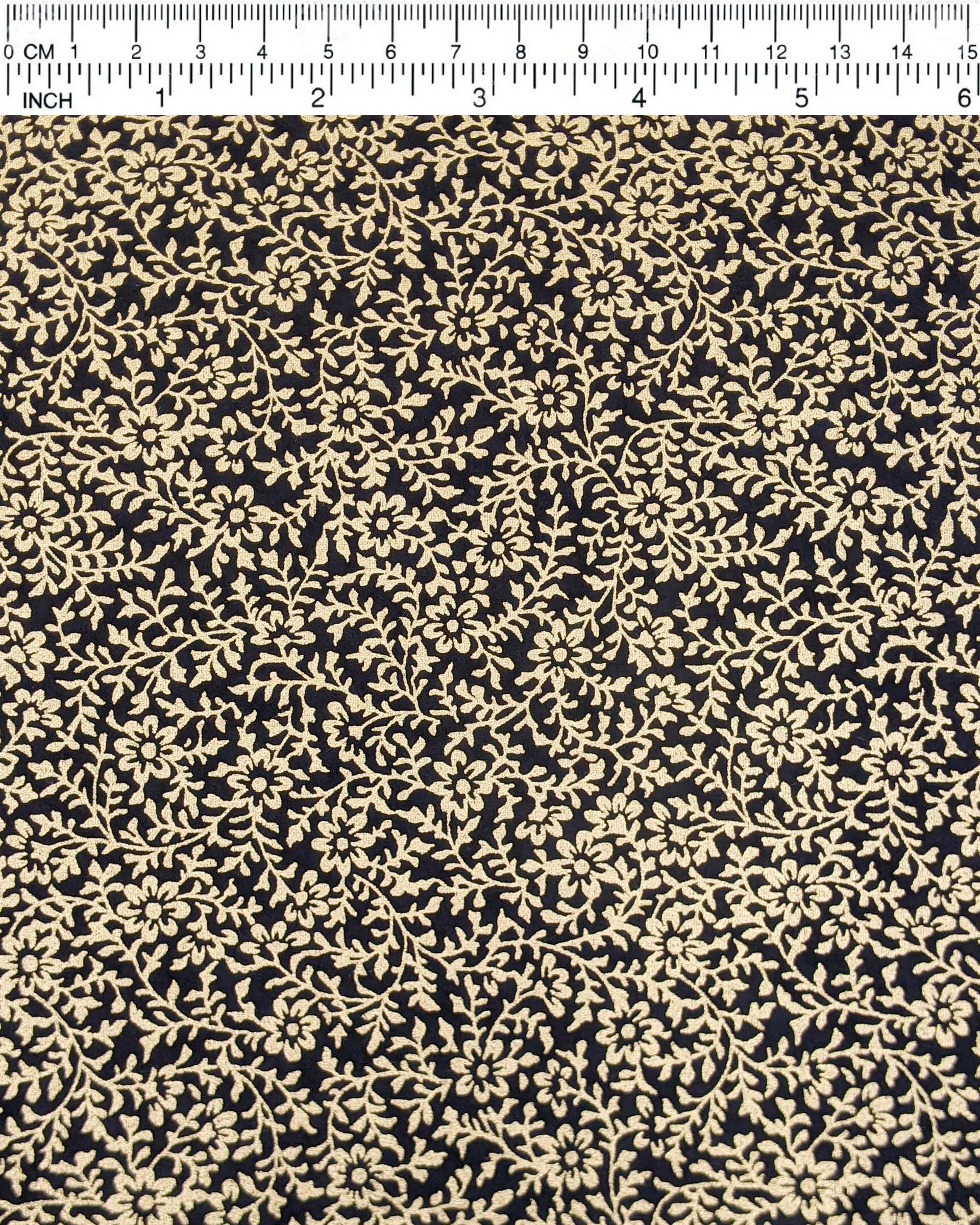 Japanese chiyogami paper featuring a metallic gold floral motif on a black background.