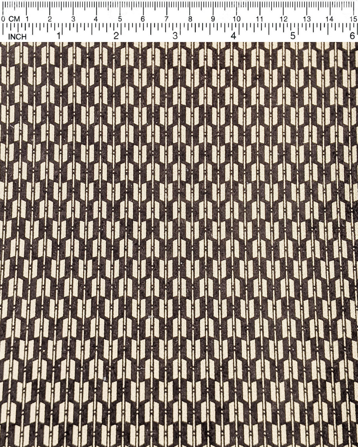 Japanese chiyogami paper featuring a traditional metallic gold yagasuri (arrow fletching) pattern on a gray background, shown next to a ruler for size reference.