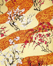 Japanese chiyogami paper featuring pink and white plum and cherry blossom trees set against a metallic gold and red water ripple pattern on a gold background.

