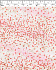 Japanese chiyogami paper featuring small red and metallic gold cherry blossoms on a gradient light pink background, shown next to a ruler for size reference.