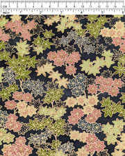 Japanese chiyogami paper featuring assorted green, pink, beige, and gray maple leaves with dark gray and metallic gold dotted maple leaves on a dark gray background, shown next to a ruler for size reference.