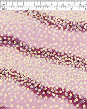 Japanese chiyogami paper featuring small white and metallic gold cherry blossoms on a gradient purple background, shown next to a ruler for size reference.