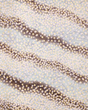 Japanese chiyogami paper featuring small white and metallic gold cherry blossoms on a gradient blue gray background.
