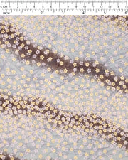 Japanese chiyogami paper featuring small white and metallic gold cherry blossoms on a gradient blue gray background, shown next to a ruler for size reference.