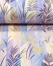 Japanese chiyogami paper featuring metallic gold, silver, and dark purple leaves on a vertically striped light purple background, shown rolled to highlight the design.