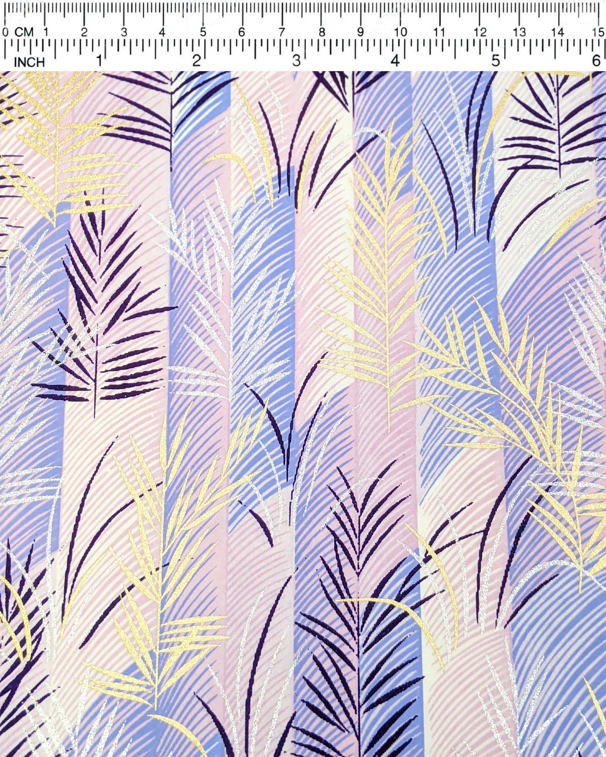 Japanese chiyogami paper featuring metallic gold, silver, and dark purple leaves on a vertically striped light purple background, shown next to a ruler for size reference.