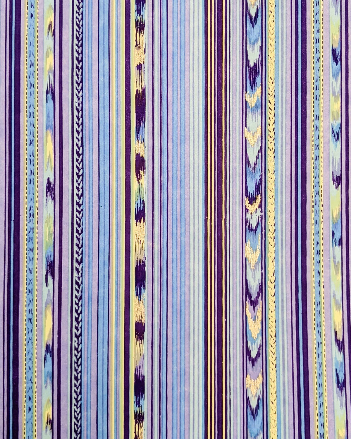 Japanese chiyogami paper featuring assorted solid and patterned vertical stripes in shades of purple, light blue, and yellow with metallic gold detail.