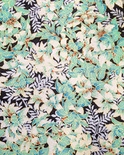Japanese chiyogami paper featuring green and white leaves with metallic silver leaves on a black background with metallic gold details.