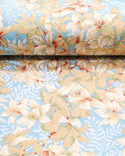 Japanese chiyogami paper featuring beige and white leaves with light blue leaves on a light blue background with metallic gold details, shown rolled to highlight the design.